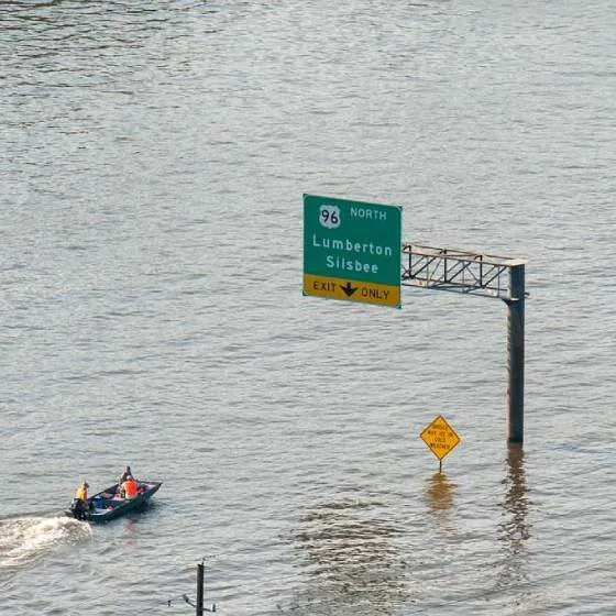 Rescue workers travel by boat across a flooded highway in the wake of Hurricane Harvey.