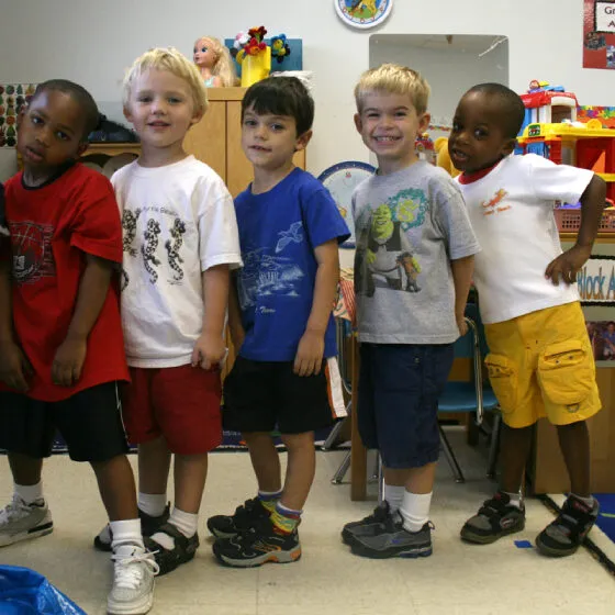 A group of preschool kids pose for a photo.