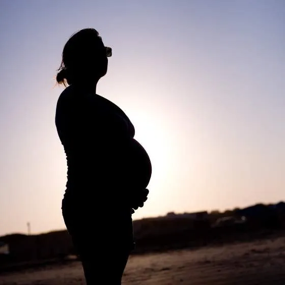A silhouette of a pregnant woman.