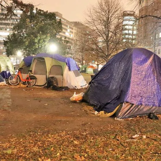 A series of tents used by unhoused populations in a city.