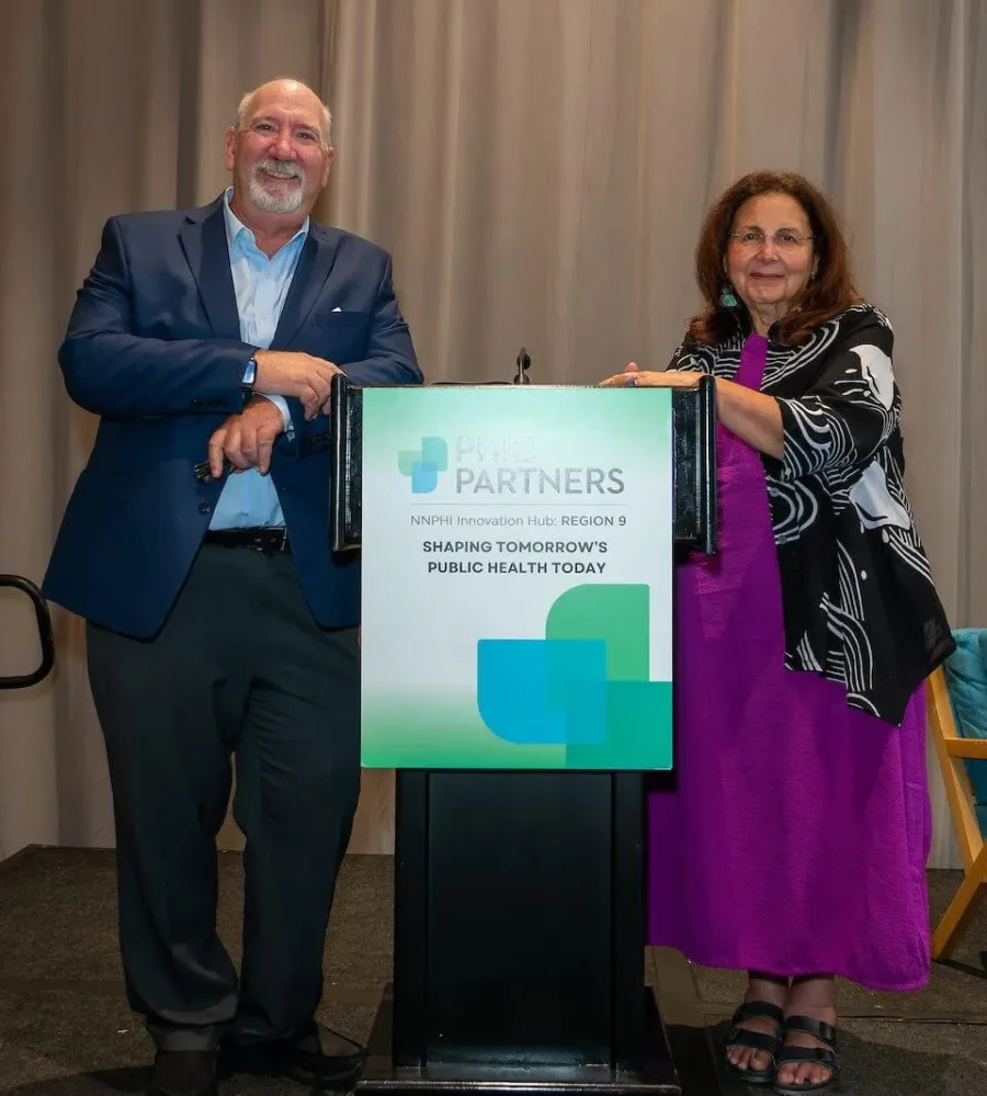 Two people stand at the podium.