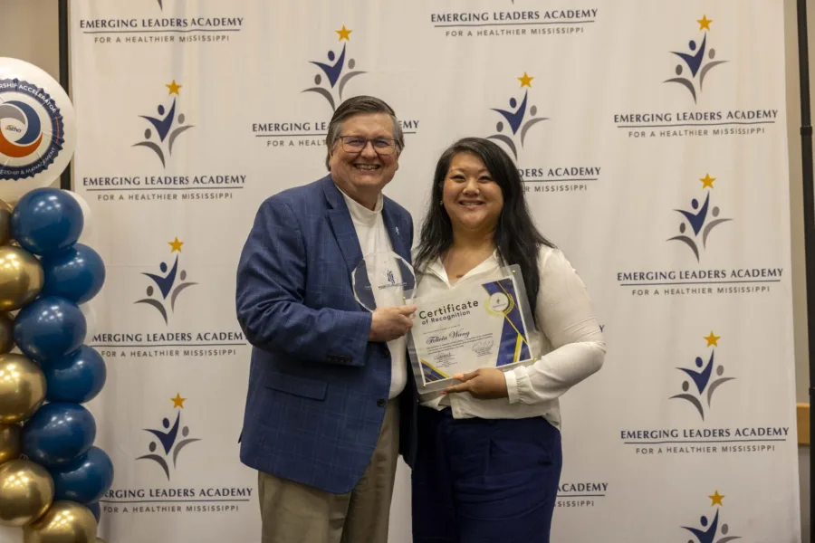Dr. Dan Edney presents a certificate to an Emerging Leaders Academy participant.