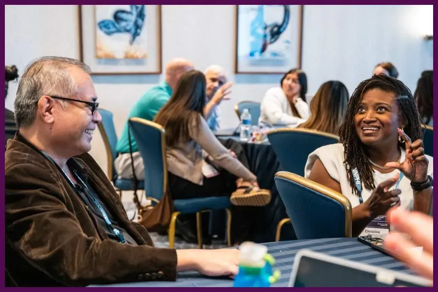 Attendees discuss AI and public health topics during an AIxPH workshop.