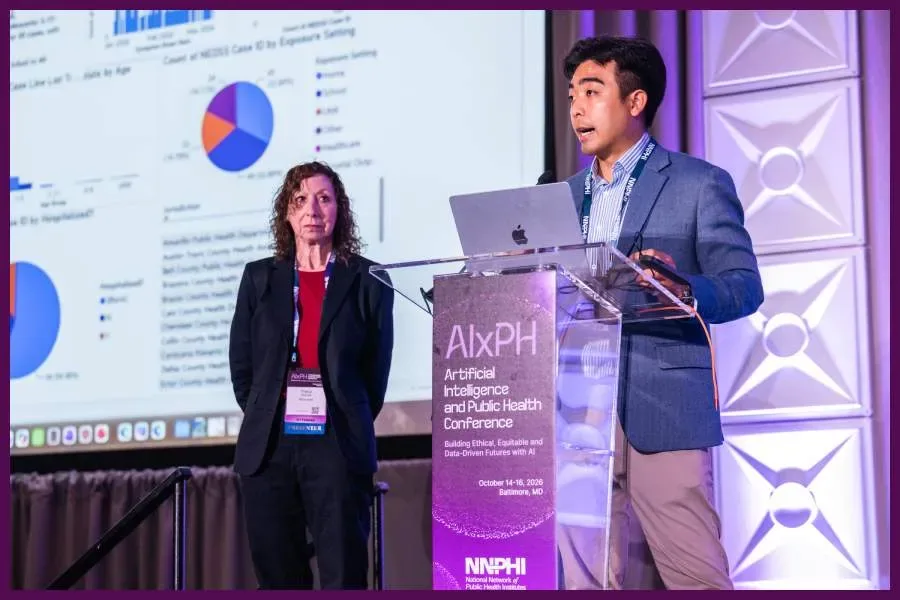 A speaker talks from the main stage podium at AIxPH.
